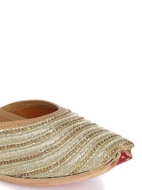 A pair of gold-toned embellished ethnic mojaris