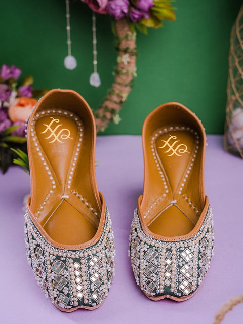 A pair of green embellished round toe flats