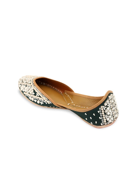 A pair of green embellished round toe flats