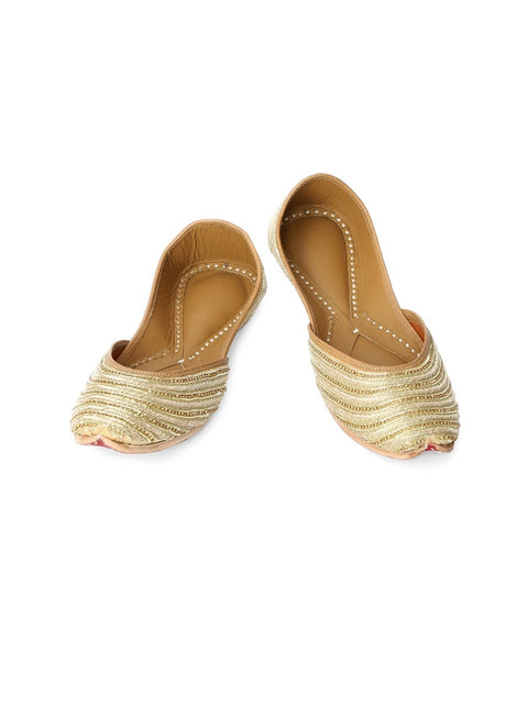 A pair of gold-toned embellished ethnic mojaris