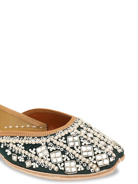 A pair of green embellished round toe flats